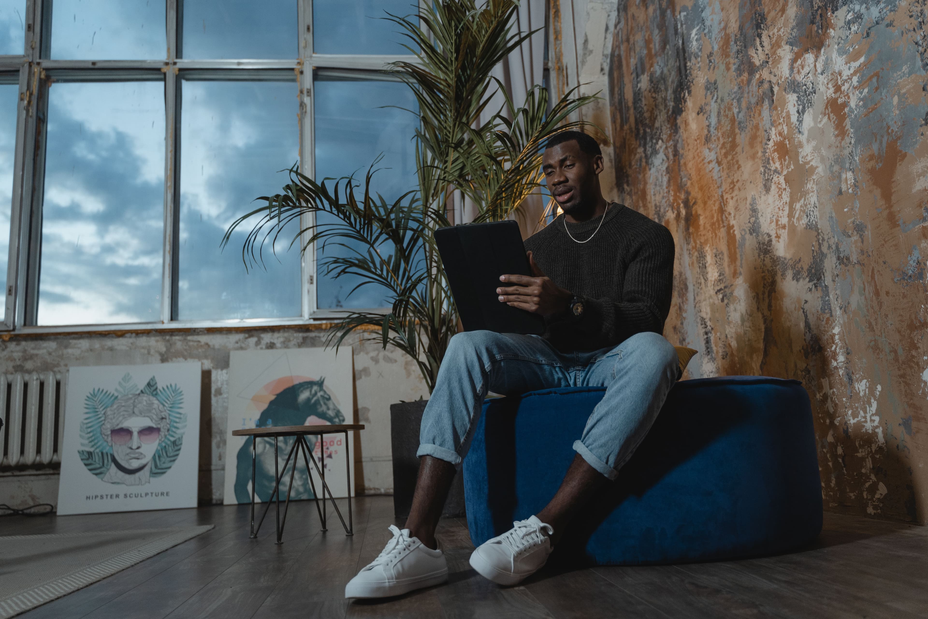 Man using a tablet in a rustic industrial loft space